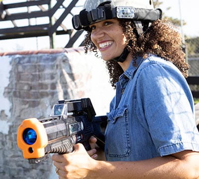 A woman aiming her gun at Laser Quest