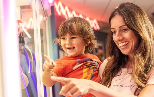 mother and son playing on arcades