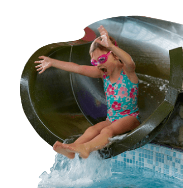 Little girl at the end of a water slide wearing blue swimming costume and pink goggles