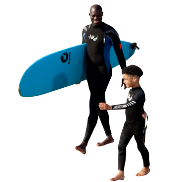 Dad and son walking along a beach holding a blue surfboard