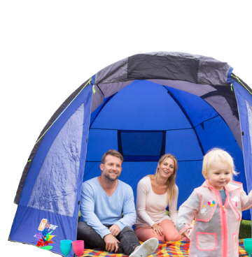 Man and woman sat inside a blue tent with young child running out
