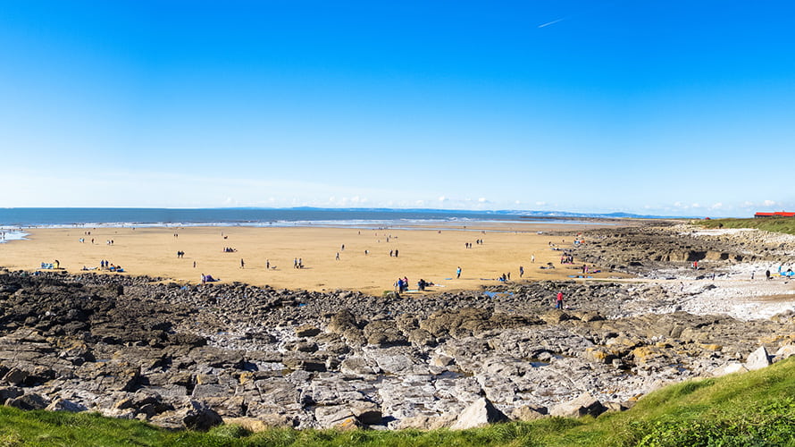 Rockpools and golden sand at Rest Bay Beach in Porthcawl on a sunny day