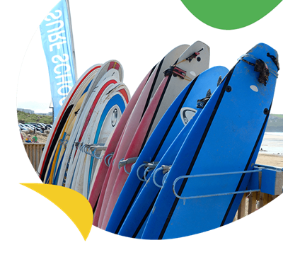Surfboards stacked up for hire