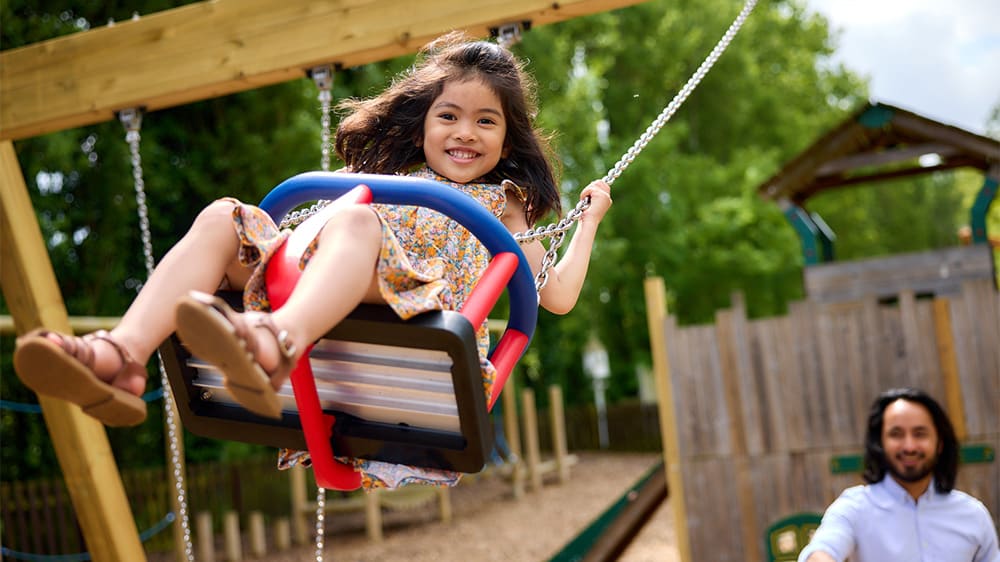 A girl on a swing in a playground