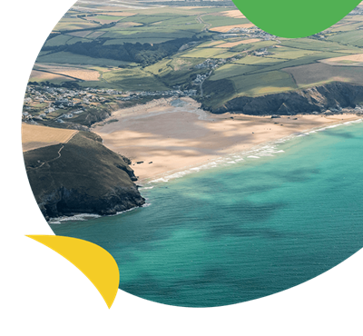 An aerial view over a sandy beach on Cornwall's north coast