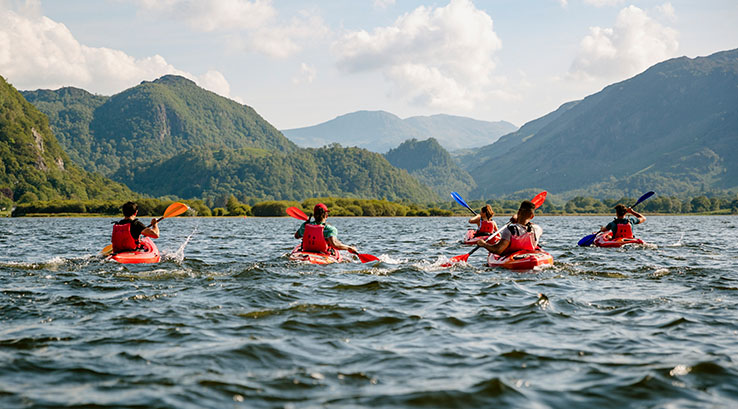 A group of people kayaking in the Lake District