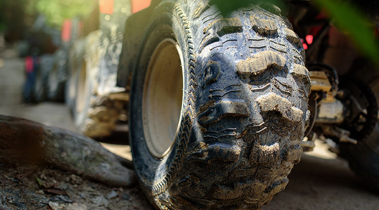 A close up of the wheels of off-road vehicles