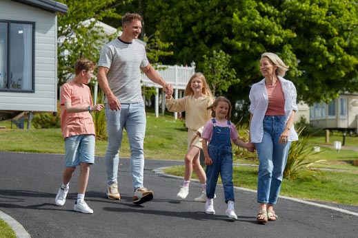Family walking hand in hand through parkdean resorts