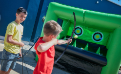 Two children taking part in hover archery