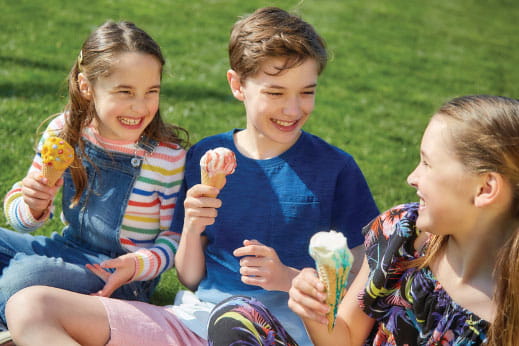 kids laughing and eating ice cream together