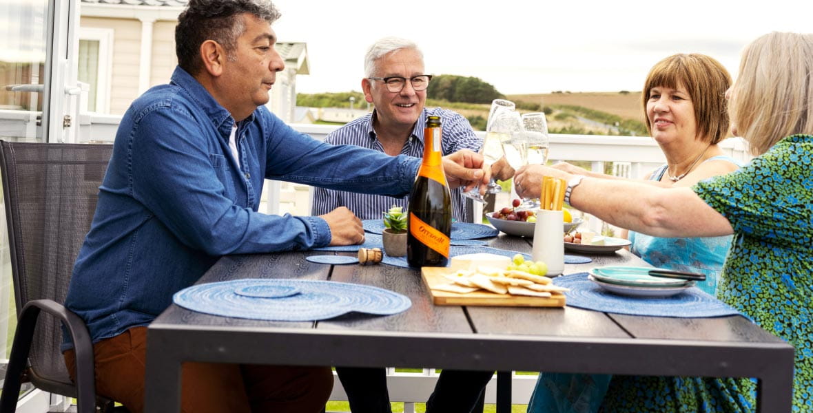 Group of older friends clinking prosecco glasses