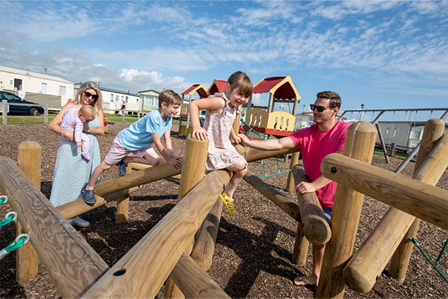 Kids playing on the playground while parents supervise at Barmston Beach