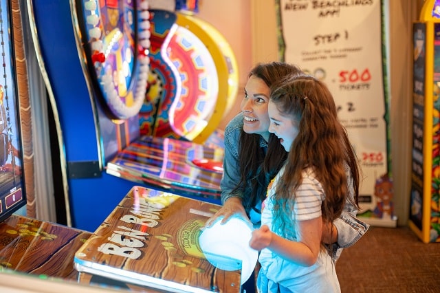 Mother and daughter playing the arcades at Bideford Bay Holiday Park