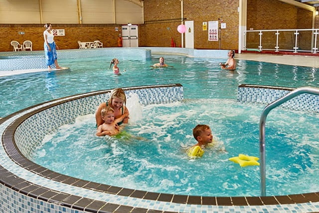 People enjoying the indoor swimming pool at Camber Sands Holiday Park