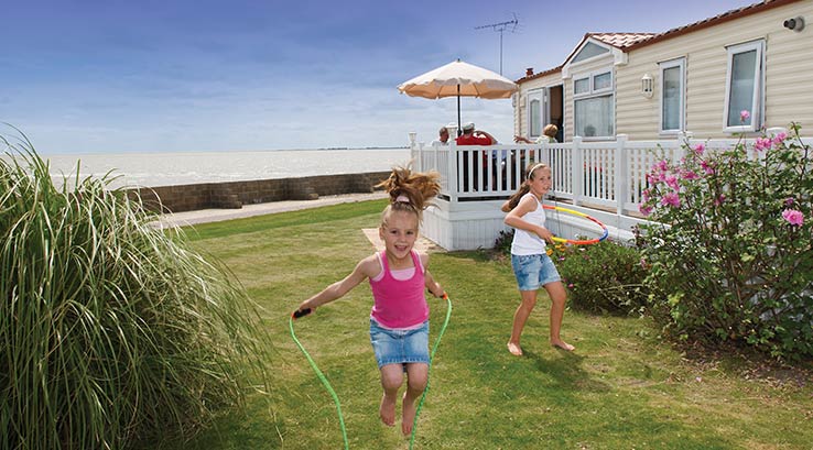 children playing next to holiday lodges