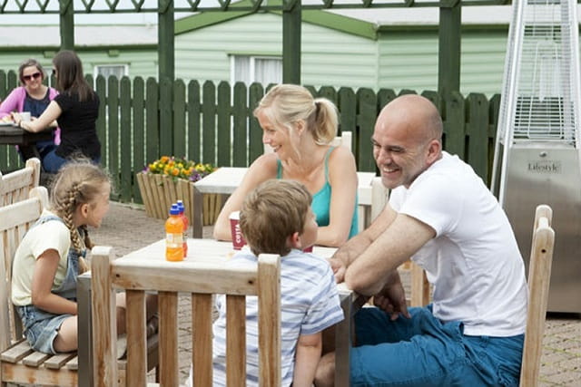 A family eating meal outside at Crantock Beach Holiday Park