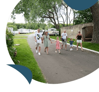 A family walking through Cresswell Towers Holiday Park