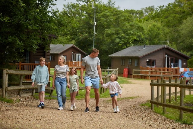 A family walking along a path at Landguard Holiday Park