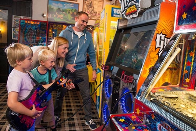 A family playing games in the amusement arcade