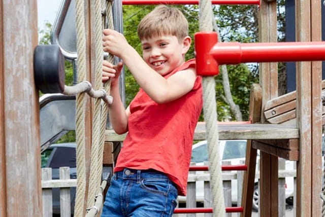 A boy playing on the adventure playground