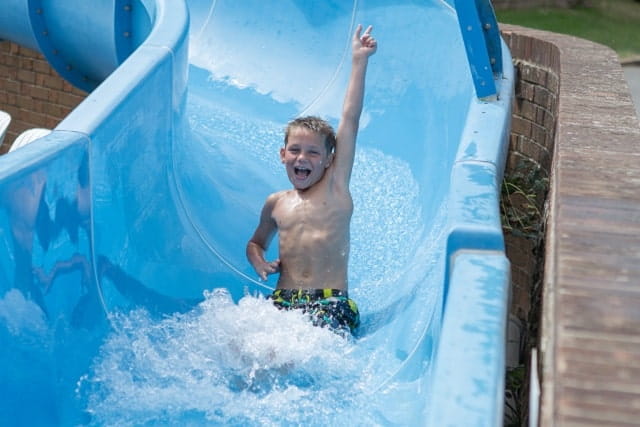 A boy sliding down the water slide at Lower Hyde Holiday Park