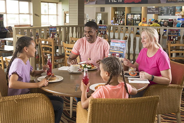 A family meal and drinks in the restaurant at Ocean Edge Holiday Park