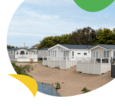 Holiday lodges looking out over the fishing lake at Romney Sands Holiday Park