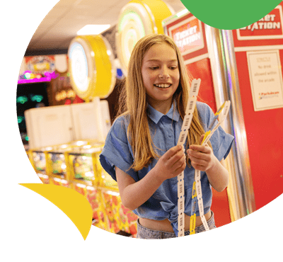 A girl with winning tickets in the amusement arcade at Sandy Bay Holiday Park