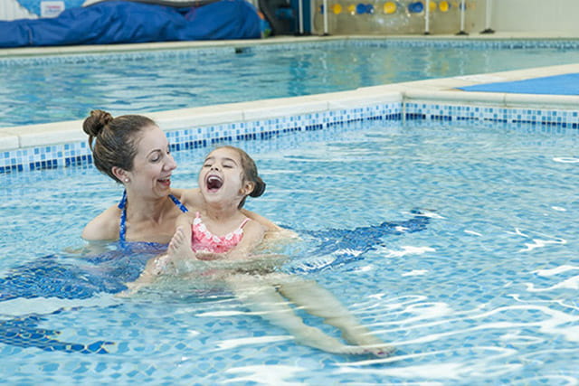 A mother and daughter relaxing in the indoor swimming pool at Sandylands