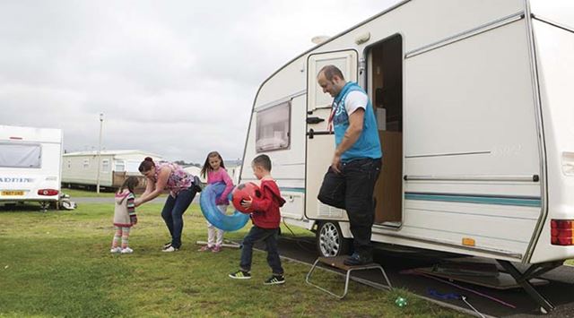 A family getting ready for some fun outside their touring caravan at Sandylands touring site