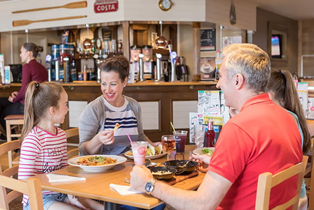 A family enjoying a meal in the restaurant at Skipsea Sands Holiday Park