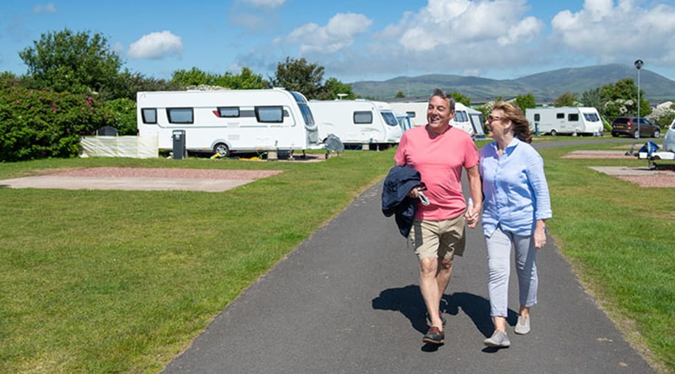 A couple strolling along the road by the touring caravans at Southerness Holiday Park