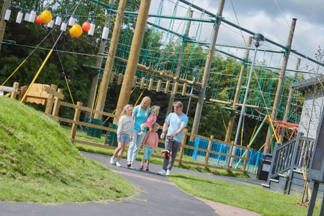 A family walking past the high ropes course at Southview Holiday Park