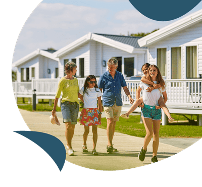 a couple walking past holiday caravans and lodges