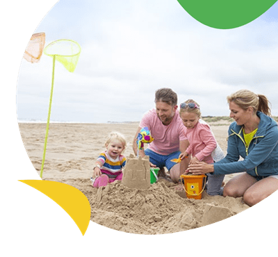 Family build sandcastles on the beach at Sunnydale Holiday Park