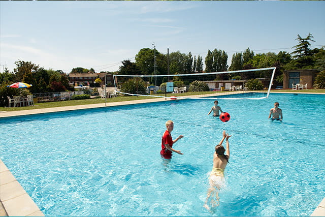 People playing volleyball in the outdoor pool at Valley farm Holiday park