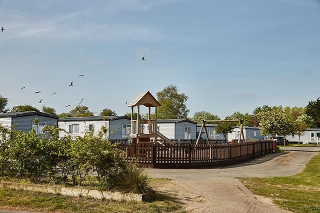 Park homes behind adventure playground at Vauxhall Holiday Park