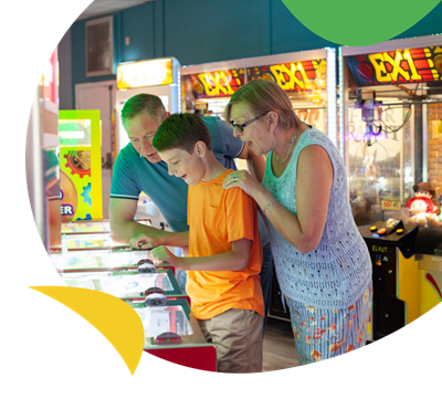 A family playing in the arcades at White Acres Holiday Park