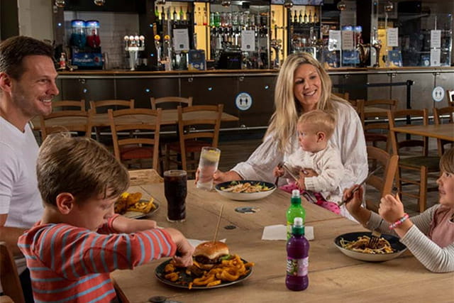 A family enjoying a meal in the restaurant at Withernsea Sands
