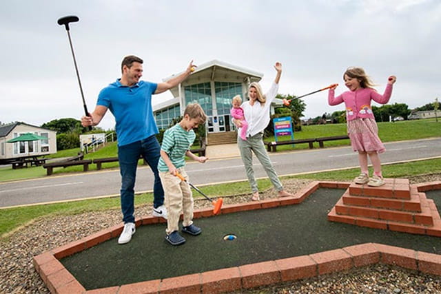 A family playing crazy golf at Withernsea Sands Holiday Park