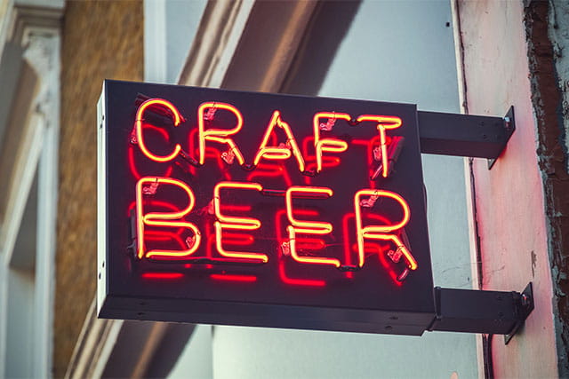 A neon sign advertising craft beer