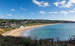 Praa Sands beach stretching around the bay in Cornwall
