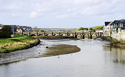 A river and bridge cross Wadebridge in Cornwall