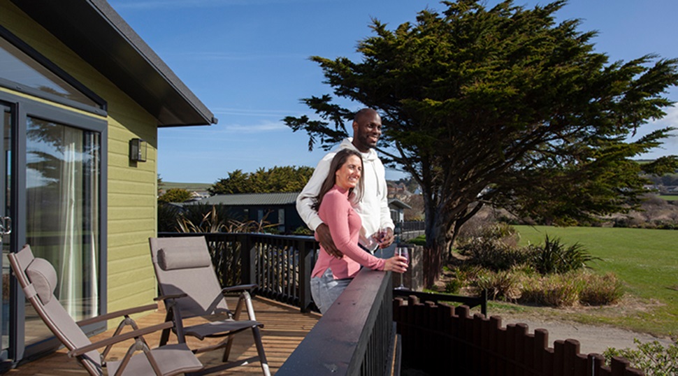Couple enjoying the view on a veranda on a sunny day