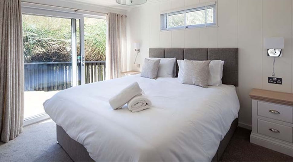 Cosy double bed in a stylish and contemporary lodge