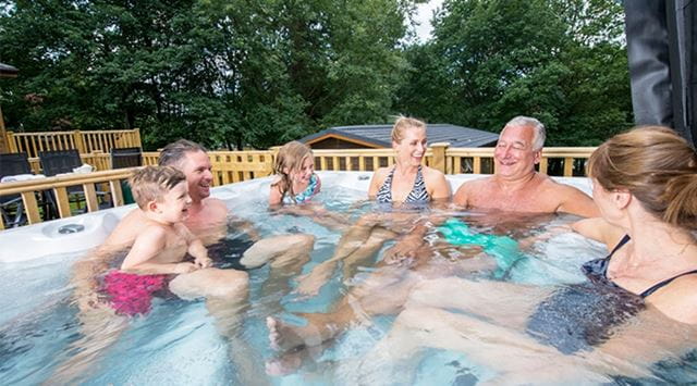 family relaxing in a hot tub