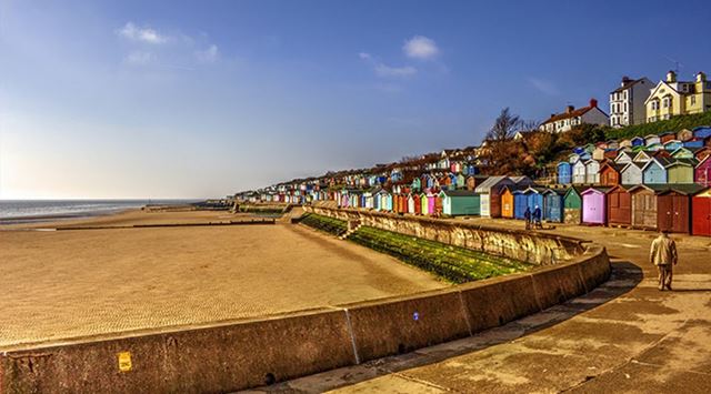 scenic view of beach huts overlooking a beach