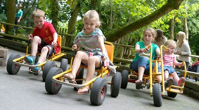 Children driving around the track on Moon Karts at Greenwood Family Park in Wales