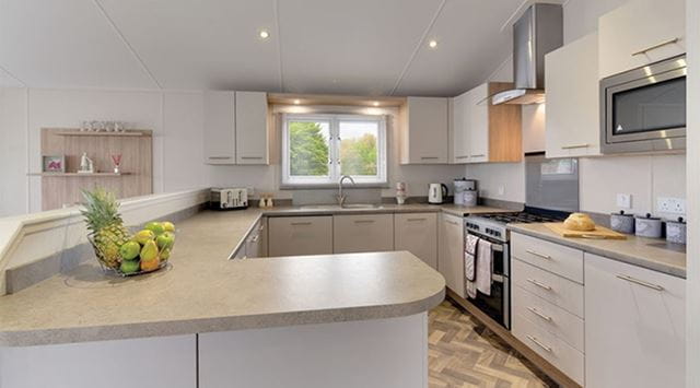 A bright and contemporary kitchen inside a luxury lodge for sale in Wales