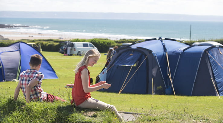 woman and boy enjoying view from campsite